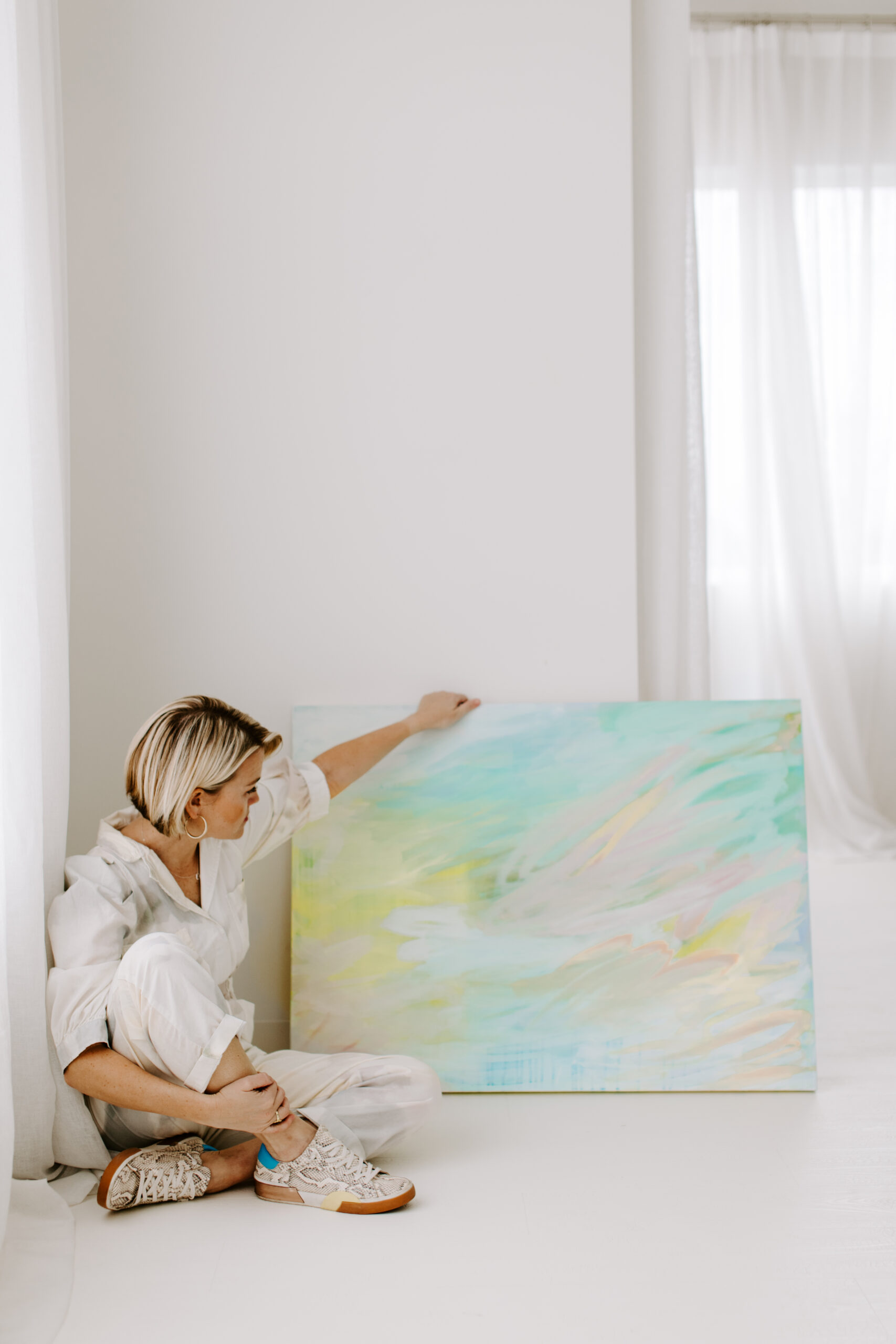 artist sitting in front of painting